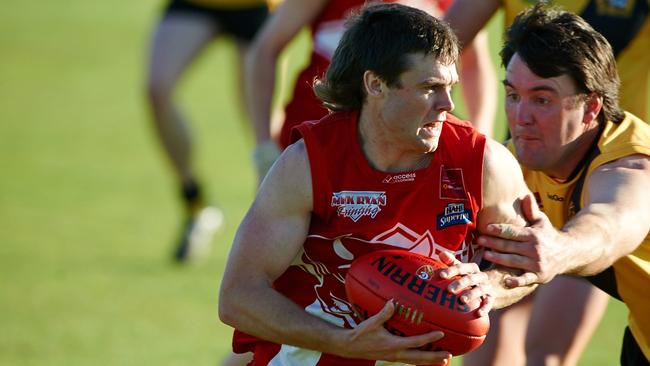 Country Football Liftout - Grand Final : League Best &amp; Fairest Brett O’Neil (South Gambier) tries to break away from North Gambier Legend Scott Flett - picture Frank Monger