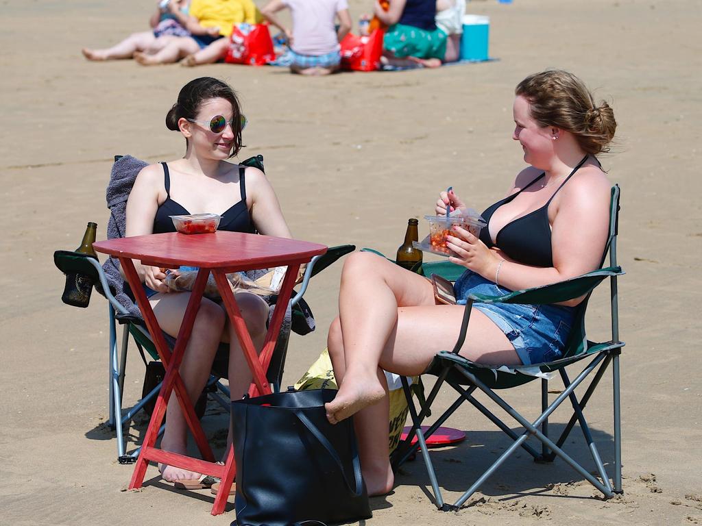 Some women set up for the day in Camber, East Sussex. Picture: Paul Lawrenson/Alamy Live News