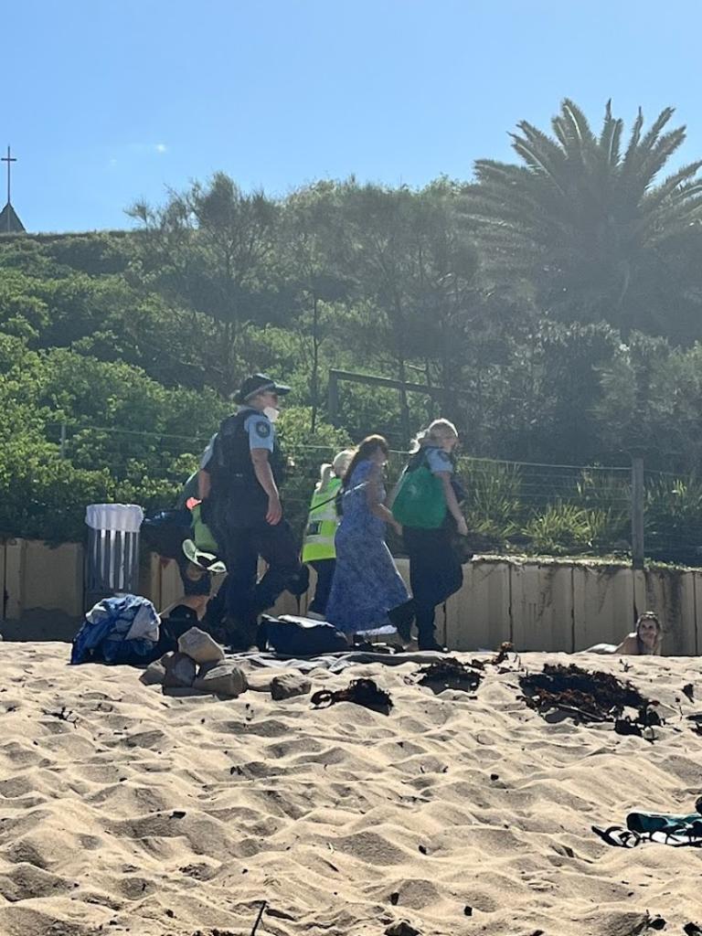 A woman was seen escorted by police who were carrying fishing equipment. Picture: Supplied.