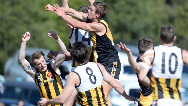 Upwey Tecoma’s Liam Beacom in a marking contest against Woori Yallock’s Ben Monkhorst. Picture: Lawrence Pinder