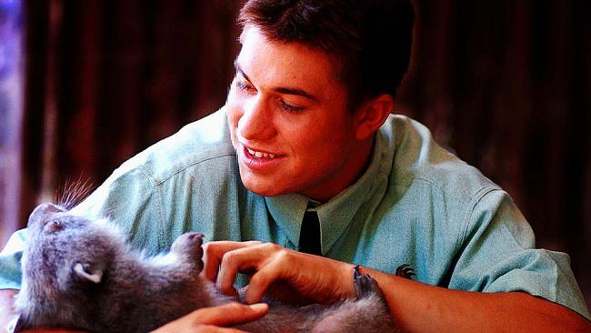 Grant Skinner cradles wombat Buddy on February 9, 2000. Picture: Jason Lindsay