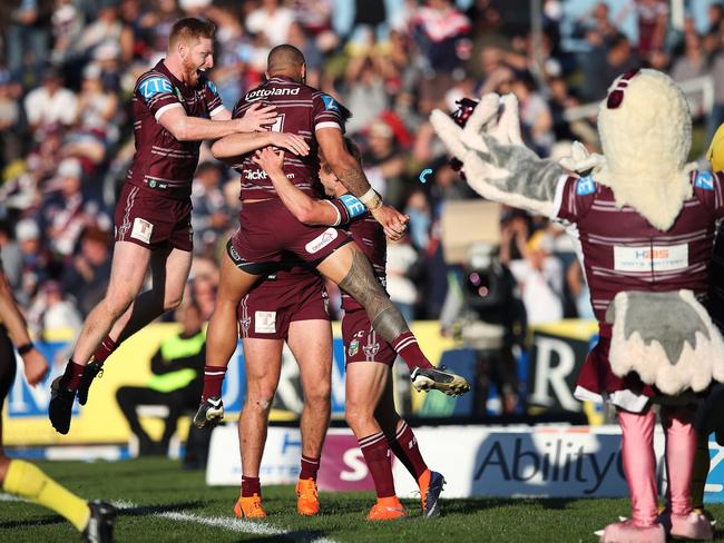 Manly's Brad Parker and Frank Winterstein leap onto Daly Cherry-Evans after scoring to seal Manly’s upset win over the Roosters at Brookvale. Picture: Phil Hillyard