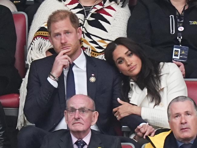 Meghan Markle places a protective hand on an emotional Prince Harry at the Invictus Games. Picture: Getty Images