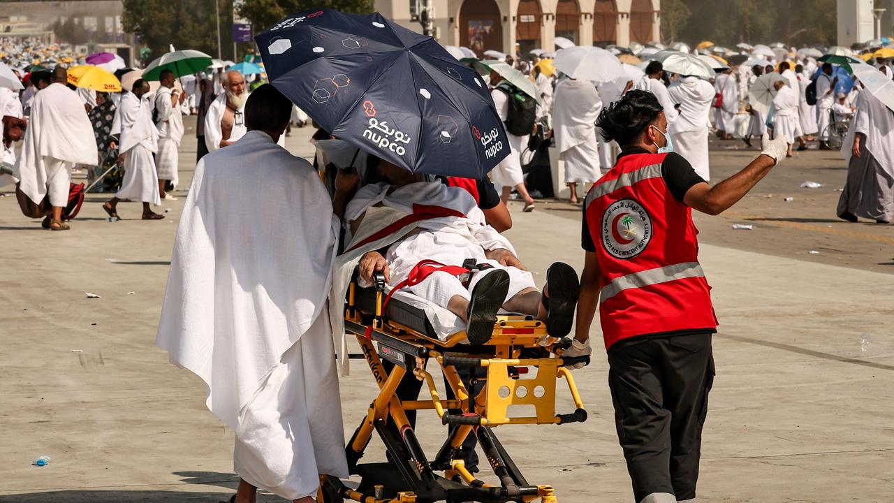 Medical team members evacuate a Muslim pilgrim affected by the scorching heat during the annual hajj pilgrimage on June 15. More than 1300 pilgrims died. Picture: Fadel Senna / AFP