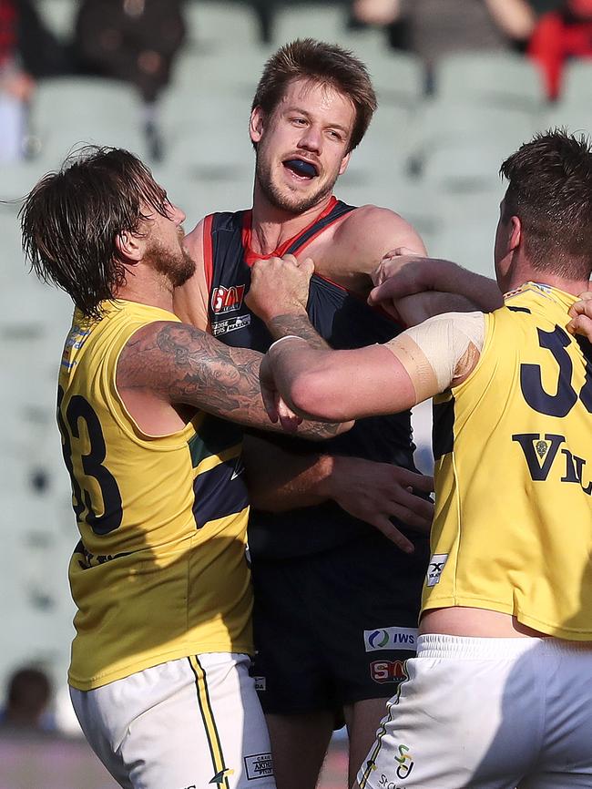 Brady Dawe flies the flag for the Redlegs in last year’s Second Semi-Final win against the Eagles. Picture SARAH REED