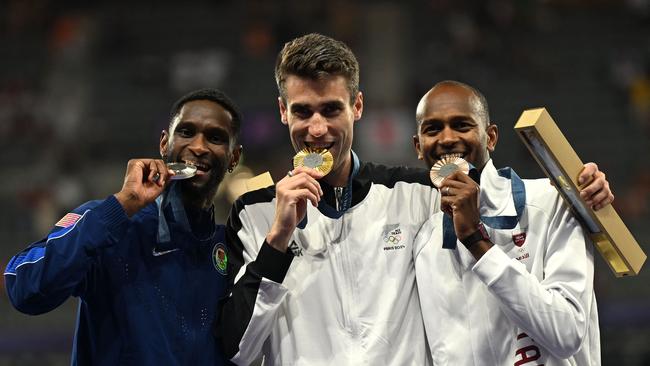 McEwen, Kerr and Barshim celebrate on the podium. (Photo by MARTIN BERNETTI / AFP)