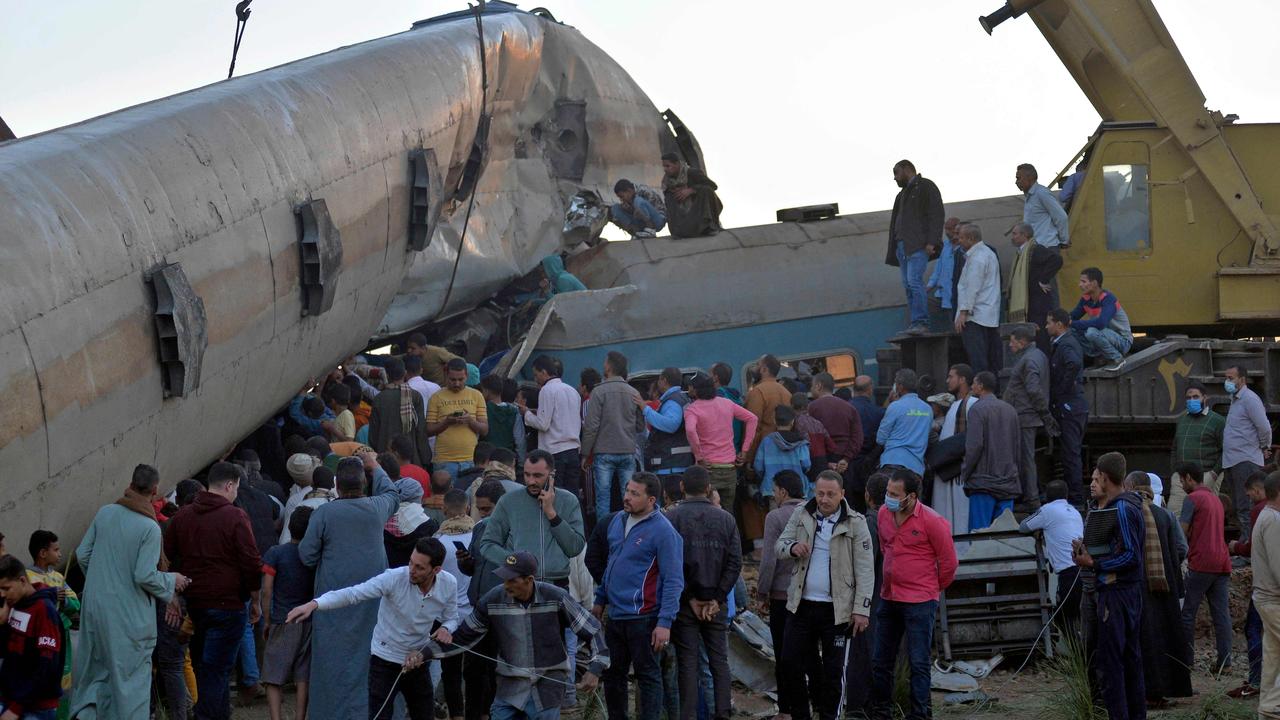 People gather around the wreckage of the two trains. Picture: AFP