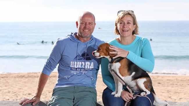 Zali Steggall pictured with her husband Tim Irving and their dog Charli at Manly Beach after Zali won the seat of Warringah the night before. Picture by Damian Shaw