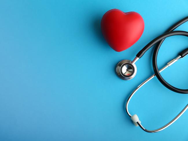 red heart and stethoscope are on blue background top view with copy space