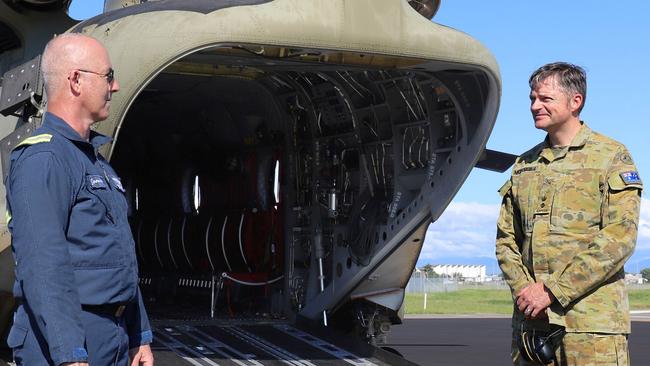 Former Australian Army technician avionics and current Boeing aircrewman aechnician instructor, Greg Maiden (left) from the School of Army Aviation is congratulated by the Commanding Officer of the 5th Aviation Regiment, Lieutenant Colonel Christopher McDougall, after completing 5000 hours of flying in the CH-47 Chinook at RAAF Base Townsville, Queensland. Photo: TPR Lisa Sherman