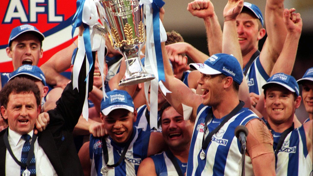 Carey with football coach Denis Pagan and team holding the AFL Premiership Cup after North Melbourne defeated Carlton in the Grand Final in 1999.