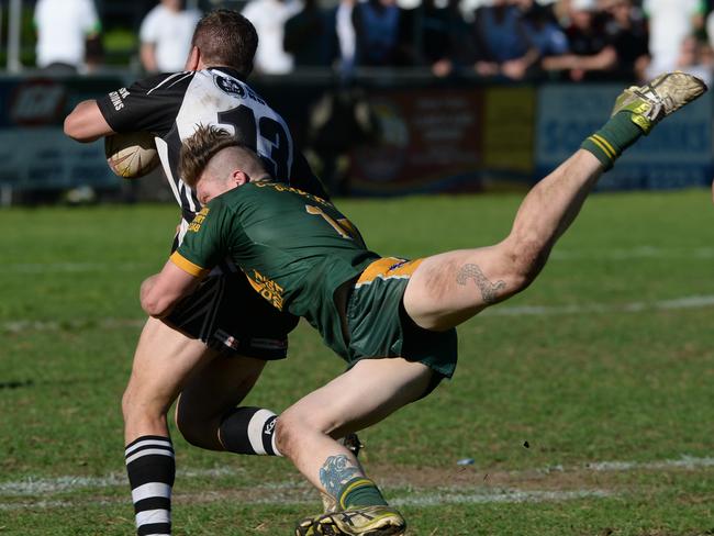 Matt White tries to escape a Mittagong defender. Picture: Ian Svegovic