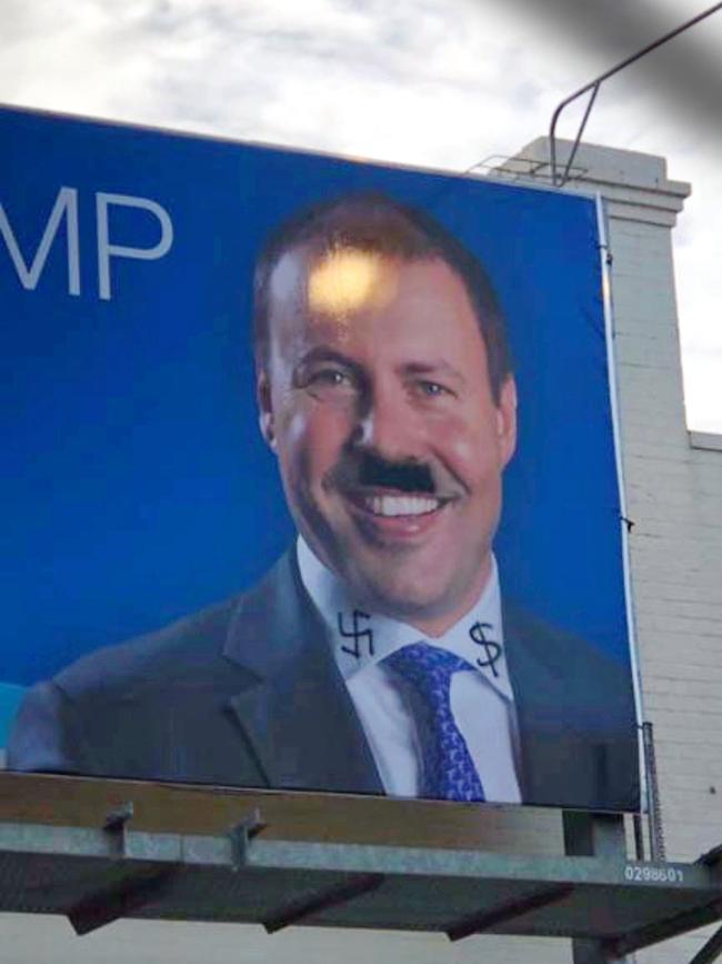 A Josh Frydenberg campaign billboard defaced with Nazi symbolism.