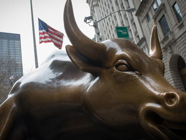 (FILES) This file photo taken on December 8, 2016 shows the Wall Street Bull sculpture is seen in the Financial District in New York.  Wall Street opened on the upside, with the Dow pushing further higher after having finished Monday at a fourth-straight record high, and nearing breaking through 22,000 points for the first time ever. "US stocks are nicely higher in early action, with the global markets reacting positively to the continued mostly upbeat earnings season and favourable manufacturing data out of Europe and Asia," said analysts at Charles Schwab brokerage.  / AFP PHOTO / Bryan R. Smith