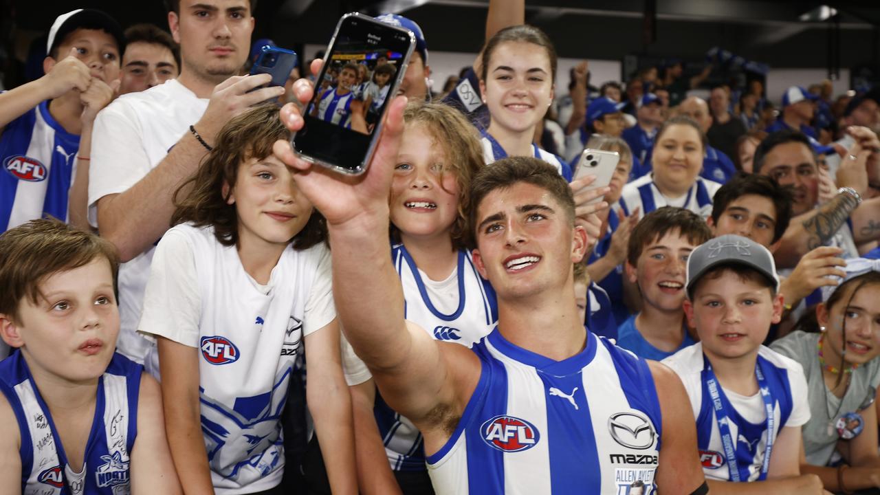 MELBOURNE, AUSTRALIA - MARCH 18: Harry Sheezel of the Kangaroos celebrates with fans after winning the round one AFL match between North Melbourne Kangaroos and West Coast Eagles at Marvel Stadium, on March 18, 2023, in Melbourne, Australia. (Photo by Daniel Pockett/Getty Images)