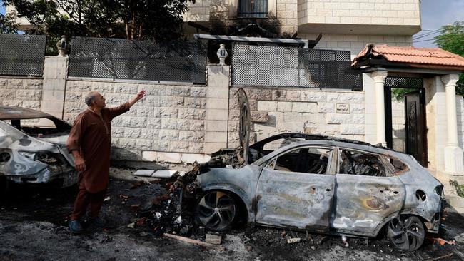 A man points to damage to his house and car a day after an attack by Jewish settlers on the village of Jit, near Nablus, in the occupied West Bank on August 16. Picture: AFP