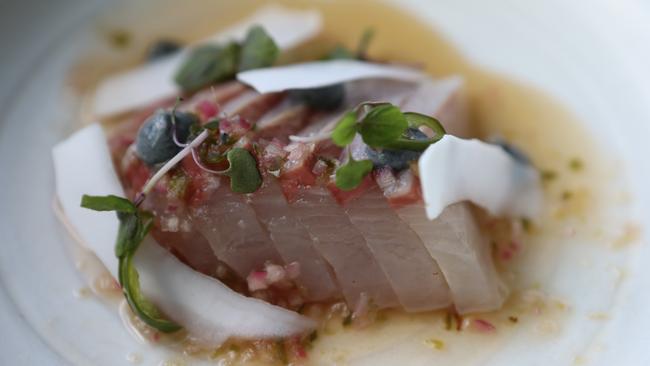 The kingfish sashimi dish with black sesame, lime and coconut. Picture Glenn Hampson