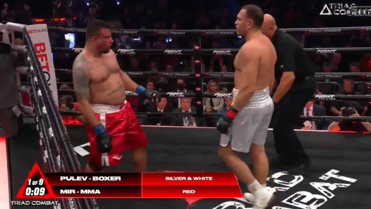 Frank Mir wobbles on his feet as Kubrat Pulev waits for the ref to step in.