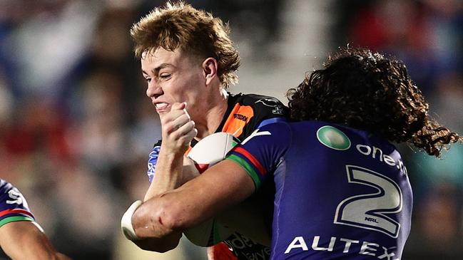 AUCKLAND, NEW ZEALAND - JULY 26: Lachlan Galvin of the Wests Tigers is tackled by Te Maire Martin (L) and Dallin Watene-Zelezniak of the Warriors during the round 21 NRL match between New Zealand Warriors and Wests Tigers at Go Media Stadium Mt Smart, on July 26, 2024, in Auckland, New Zealand. (Photo by Dave Rowland/Getty Images)