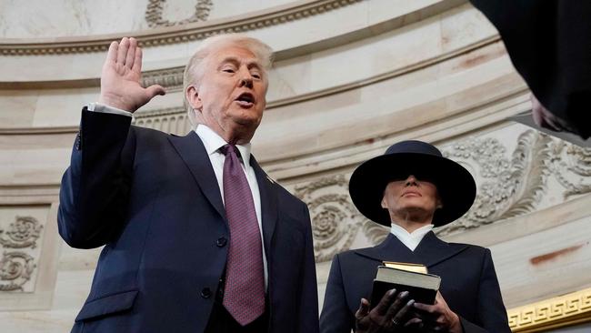 Donald Trump being sworn in as president, with Melania Trump holding a Bible. Picture: Morry Gash/AFP