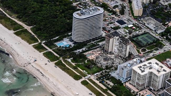 This aerial view, shows search and rescue personnel working on site after the partial collapse of the Champlain Towers South in Surfside, north of Miami Beach.