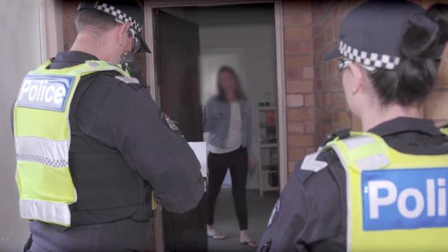 Victoria Police carry out a spot check on a person who returned home from overseas last week. Picture: Victoria Police