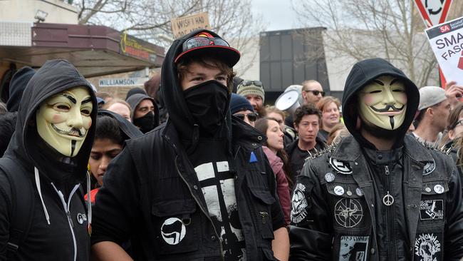 Protesters wear masks at the rally. Picture: Rob Leeson.