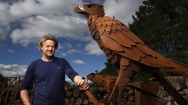 Tasmanian sculptor Folko Kooper at his sculpture garden on his property with sculpture of a hawk for the Verge Hotel in Launceston. Picture: Zak Simmonds