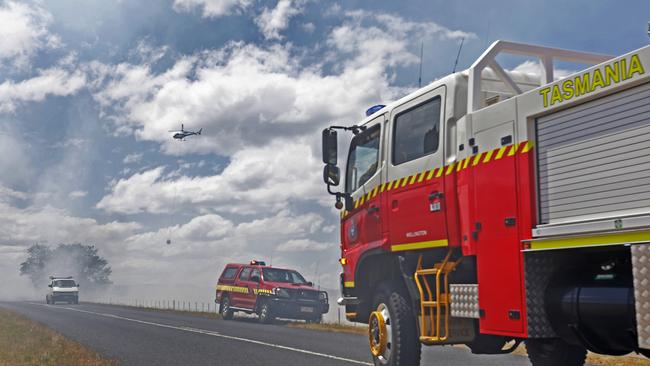 Firefighters look to contain a fire along Elderslie Rd at Elderslie. Picture: ZAK SIMMONDS