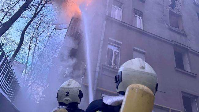 Firefighters extinguish flames following a Russian drone attack on Kyiv on January 1. Picture: Handout/Ukrainian State Emergency Service/AFP