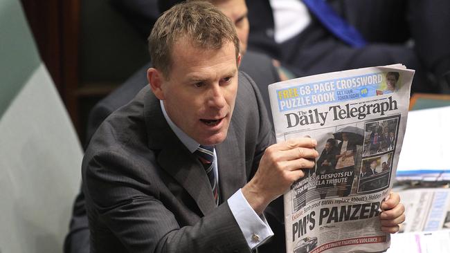 Labor MP Nick Champion holds a copy of The Daily Telegraph during question time at Parliament House in Canberra in 2013.