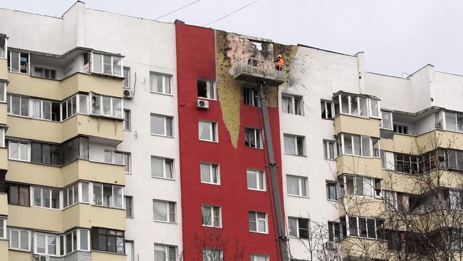 Specialists work on the facade of a damaged apartment building following a drone attack in Moscow. Picture: AFP