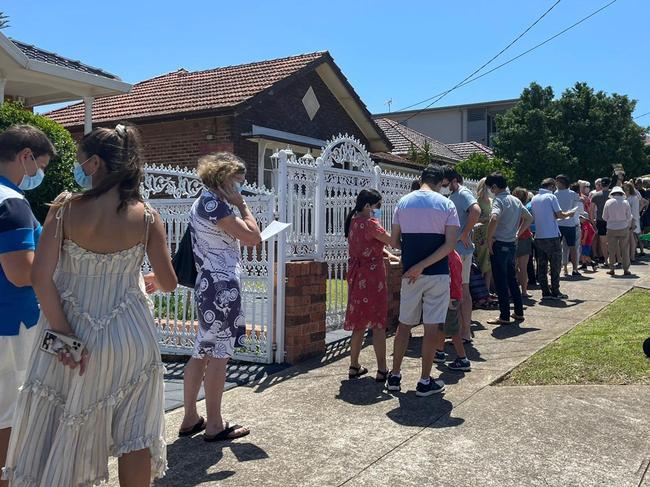 House hunters line up outside the open for inspect for a home in Earlwood on January 23, 2021. NSW real estate.