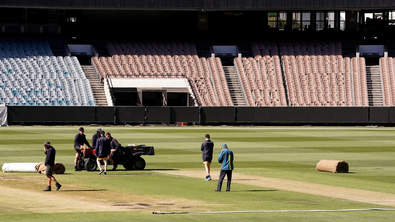 Curators inspect the pitch prior to the abandonment 2 of the Sheffield Shield match between Victoria and Western Australia at the MCG. (AAP Image/Sean Garnsworthy)