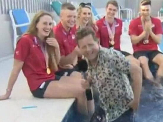 BBC presenter Mike Bushell suffered the hilarious misfortune of falling into a swimming pool live on air while interviewing Commonwealth Games swimmers