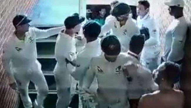 Warner being held back after an altercation with Quinton De Kock in the stairwell after the first Test.