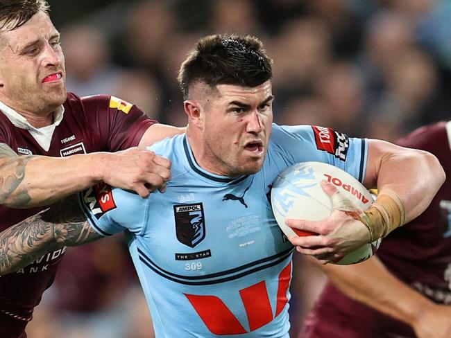 SYDNEY, AUSTRALIA - JULY 12: Bradman Best of the Blues is tackled by Cameron Munster of the Maroons during game three of the State of Origin series between New South Wales Blues and Queensland Maroons at Accor Stadium on July 12, 2023 in Sydney, Australia. (Photo by Brendon Thorne/Getty Images)