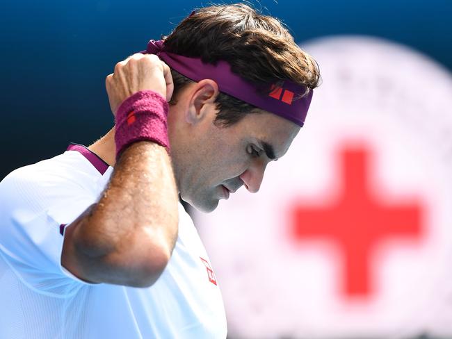 Switzerland's Roger Federer looks down as he plays against Tennys Sandgren of the US during their men's singles quarter-final match on day nine of the Australian Open tennis tournament in Melbourne on January 28, 2020. (Photo by William WEST / AFP) / IMAGE RESTRICTED TO EDITORIAL USE - STRICTLY NO COMMERCIAL USE