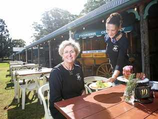 Verandah Cafe waitress Kristin Colless serves owner Sarah Robinson a coffee and some cake. Picture: Scott Powick