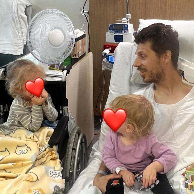 Royal Australian Navy clearance diver Dave Miln, of Seaforth, with his daughters, Isla, 3, and Anna, 1. Picture: Supplied