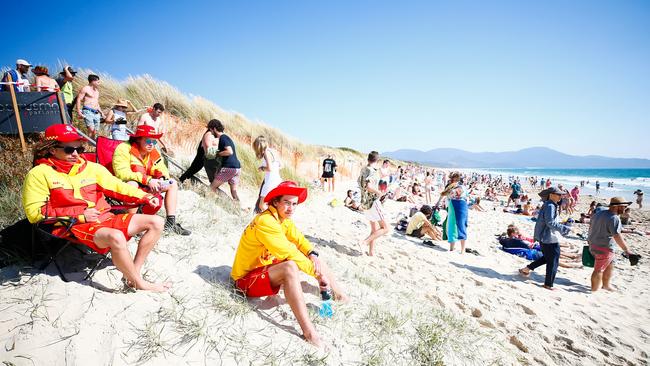 A steady stream of Falls Festival patrons make their way to Marion Bay Beach looking to cool off. Picture: PATRICK GEE