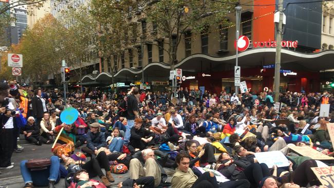 The mass "die-in" was organised by climate activists. Picture: Remy Varga