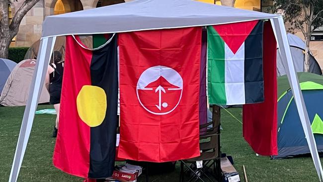 The flag of the Popular Front for the Liberation of Palestine (PFLP) was seen flying amid the placards and banners on the third day of the ‘Gaza solidarity’ encampment at the St Lucia campus of the University of Queensland in Brisbane.