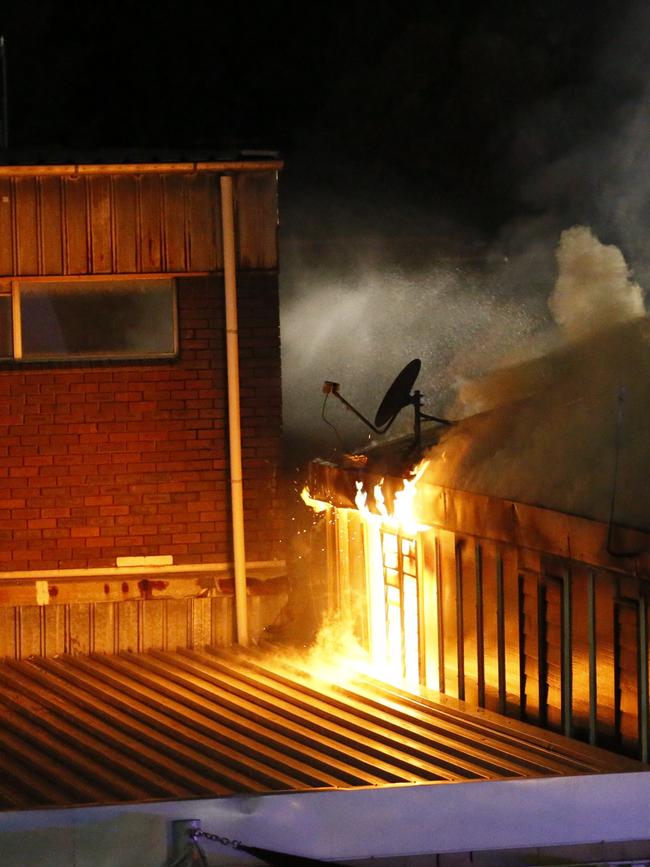 Blaze spreads to the roof. Picture: Steve Tyson