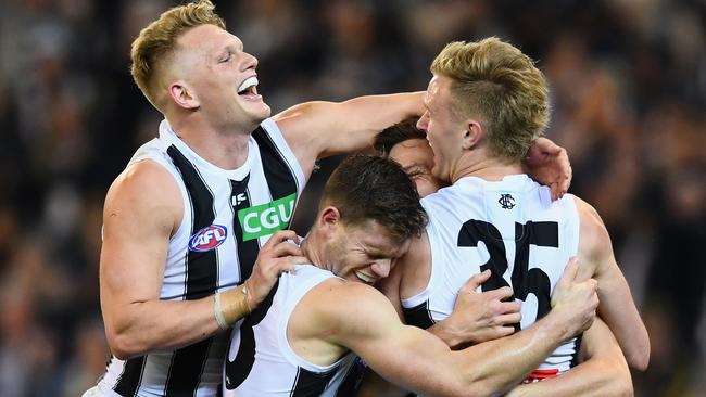 Collingwood players celebrate a late goal against Richmond. Picture: Getty Images