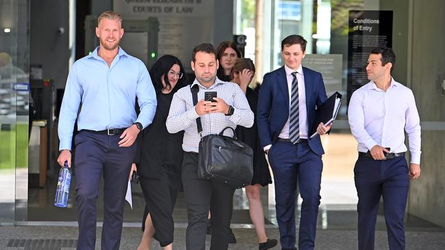 Supporters of Joshua Small, who is charged with the murder of ex-Mongol Shane Bowden, leave Brisbane Supreme Court with defence solicitor (wearing blue suit) on November 7, 2024. Picture: NewsWire / John Gass