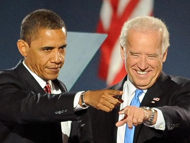 Democratic presidential candidate Barack Obama and running mate Joe Biden signal to supporters during their election night victory rally at Grant Park on November 4, 2008 in Chicago, Illinois.