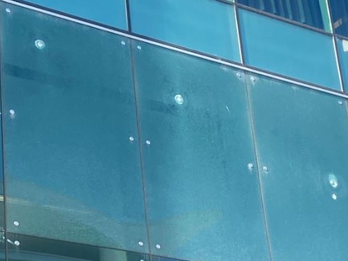 Damage caused to windows by three gunshots fired at Canberra airport. Picture: Twitter.