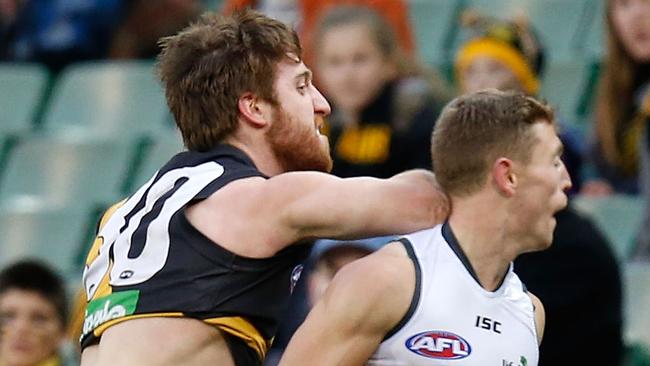 Reece Conca of the Tigers and Devon Smith of the Giants clash during the 2014 AFL Round 19 match between the Richmond Tigers and the GWS Giants at the MCG, Melbourne on August 02, 2014. (Photo: Michael Willson/AFL Media)