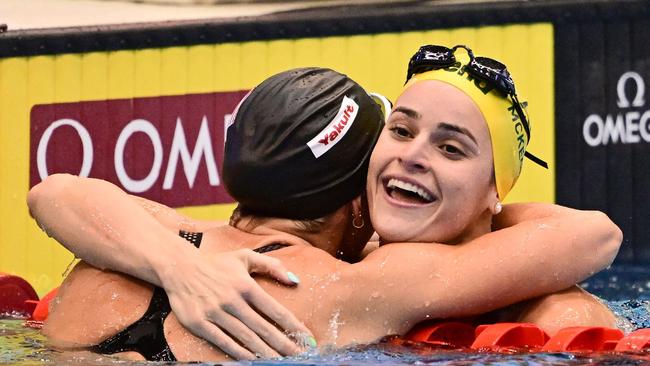 Australia's Kaylee McKeown is hugged by USA's Regan Smith